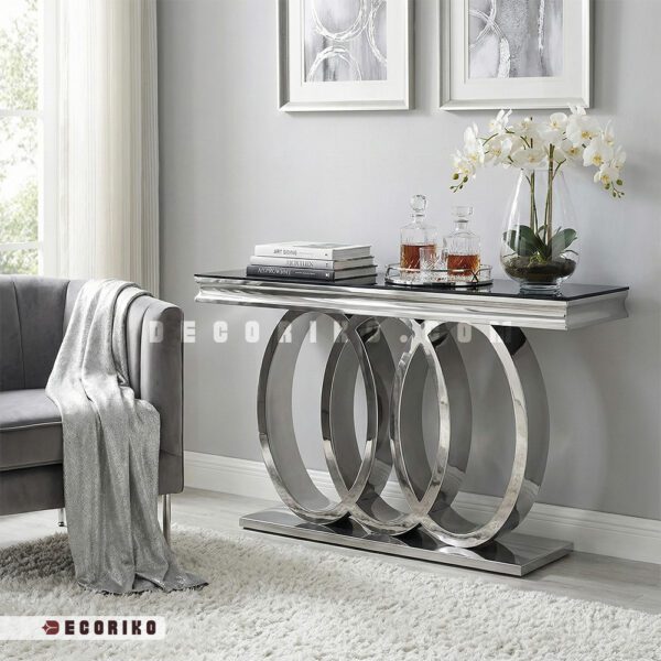 میز کنسول استیل نقره ای مدرن با طراحی سه حلقه و رویه شیشه مشکی در دکوراسیون طوسی